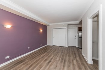 Living Room with Accent Wall at Reside on Clarendon - Photo Gallery 3