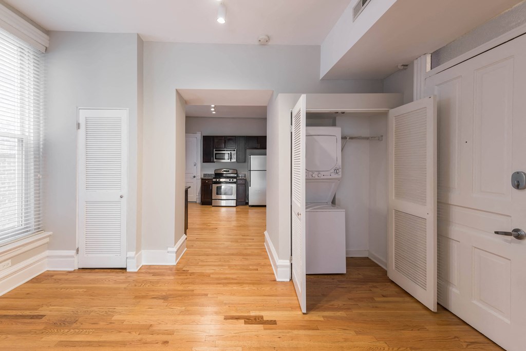 a renovated living room with a wood floor and white closets