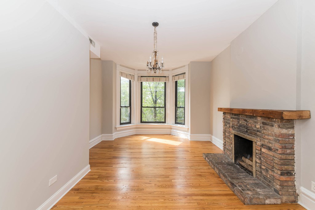 Apartment a living room with a fireplace and a large window