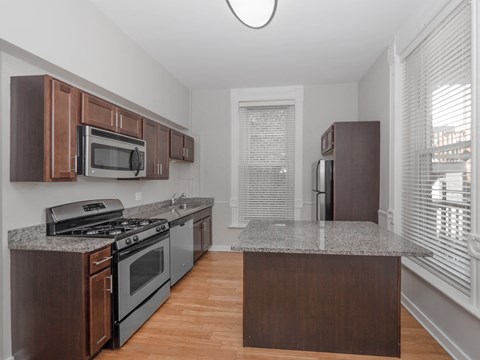a kitchen with granite counter tops and stainless steel appliances