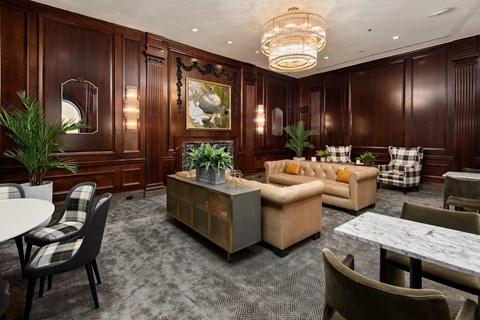 the lobby of a hotel with couches tables and chairs