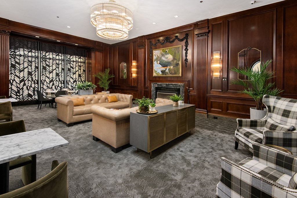 a living room with couches and chairs and a fireplace