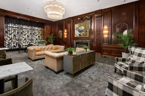 a living room with couches and chairs and a fireplace