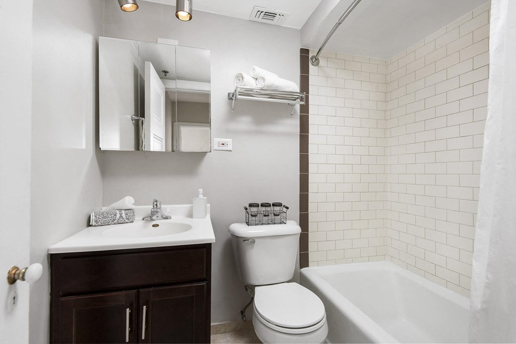a bathroom with a sink toilet and a bath tub