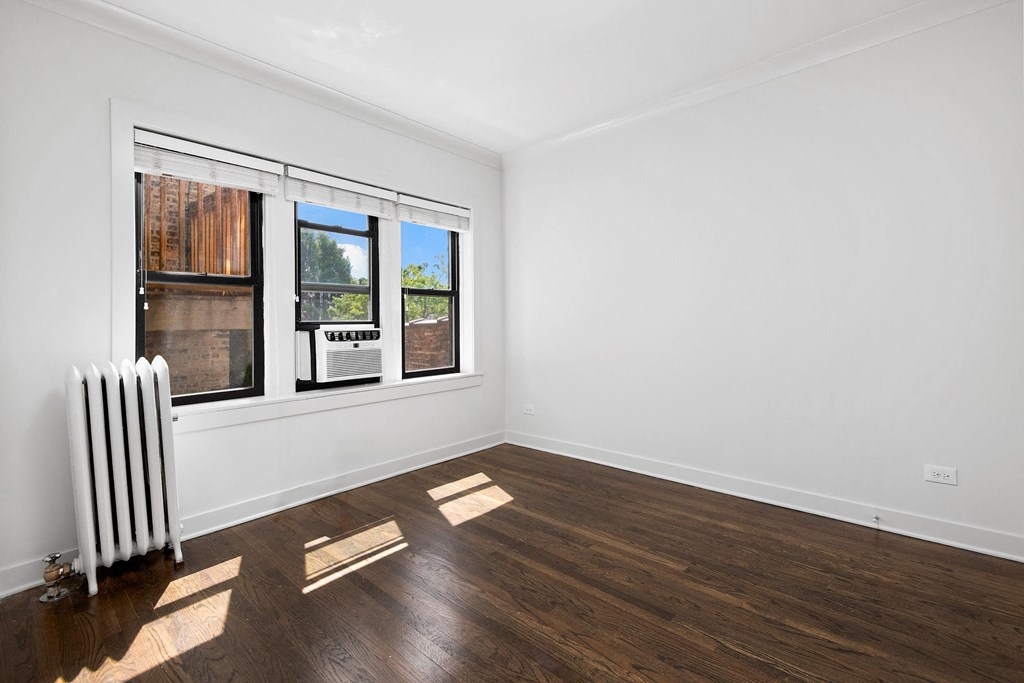 a living room with a radiator and a window