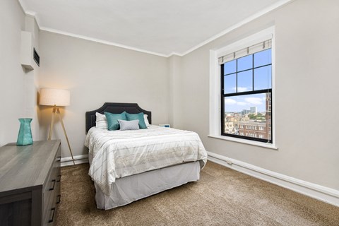 Apartment a bedroom with a bed and a window