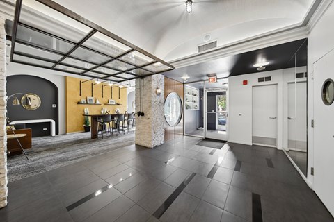 A spacious room with a grey floor and a white door.