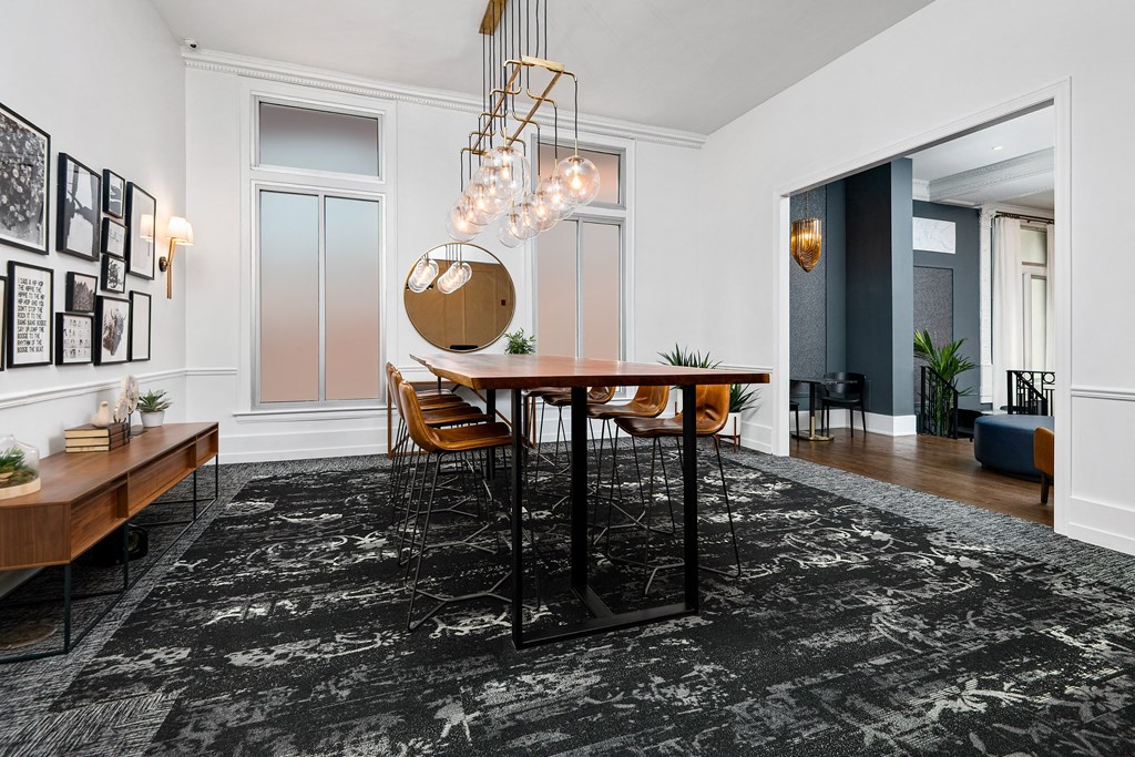Community a dining room with a table and chairs and a chandelier
