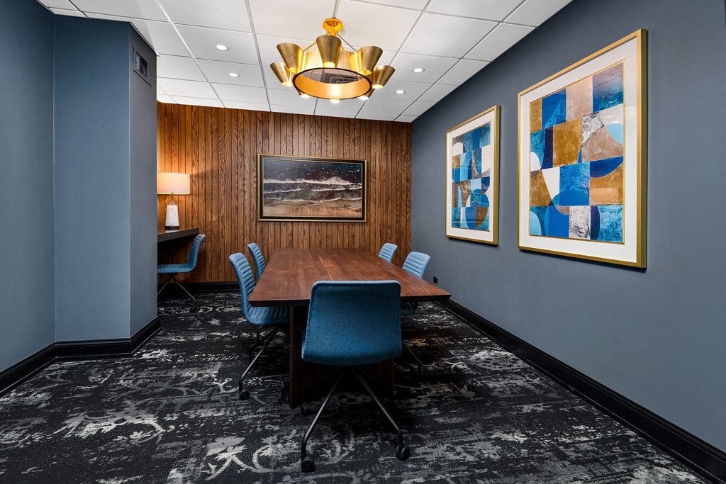 Community a conference room with a long wooden table and blue chairs