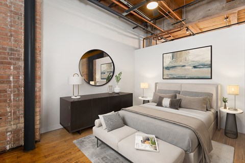 a bedroom with a bed and a mirror