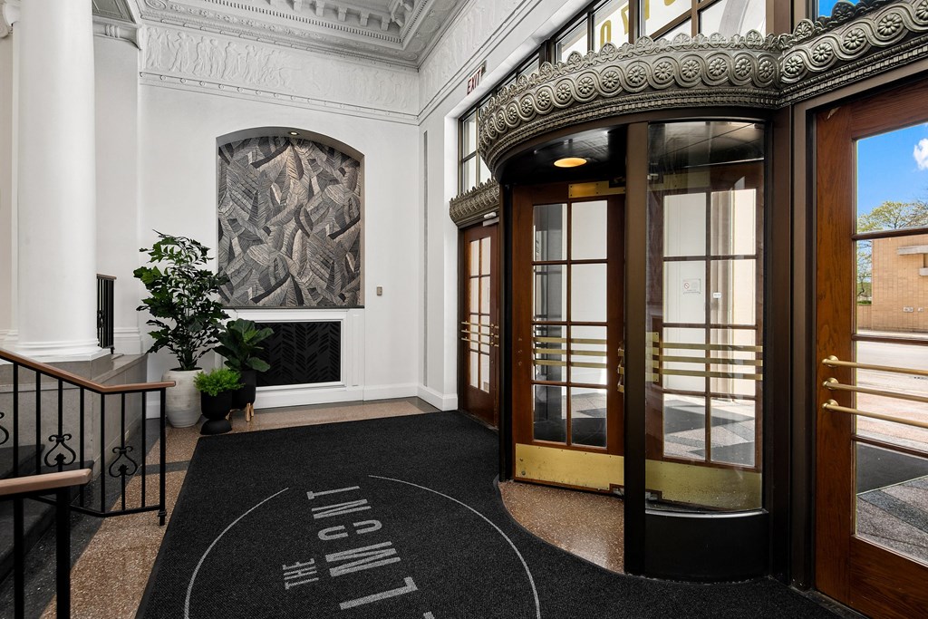 the entrance to the lobby of a building with glass doors