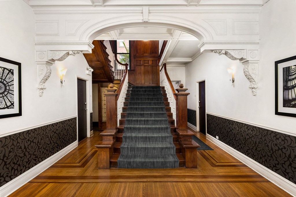 a staircase in a house with a wooden floor and a wooden