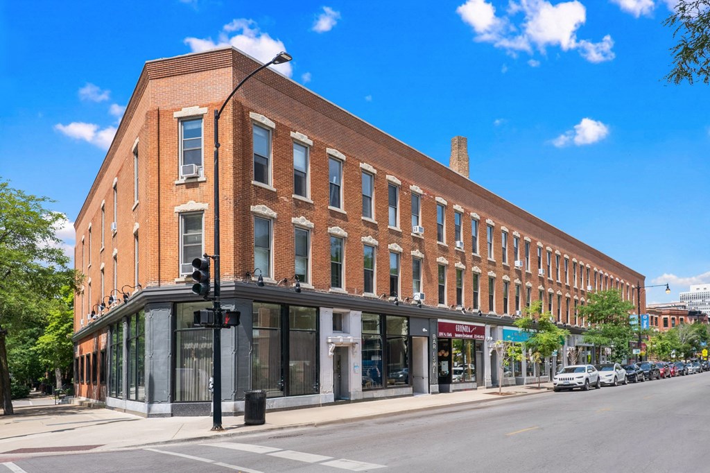 a large brick building on the corner of a city street