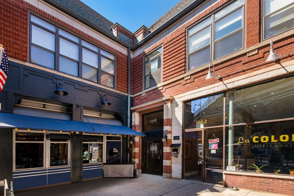 the exterior of a building with a blue awning and a window display of