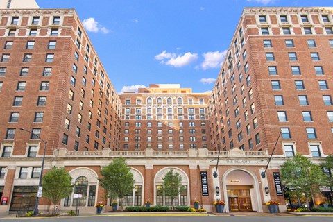 a view of two large brick buildings on a city street