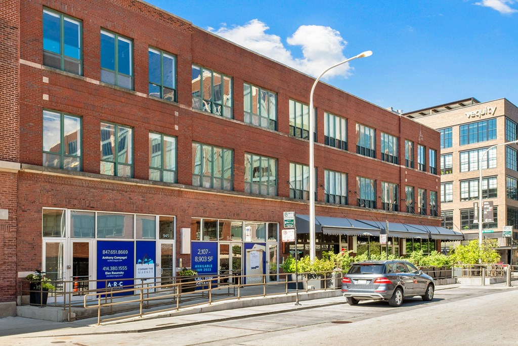 a large brick building with a car parked in front of it