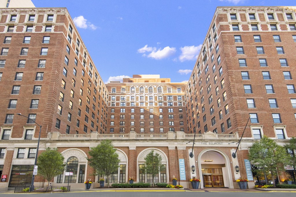 a view of two large brick buildings on a city street