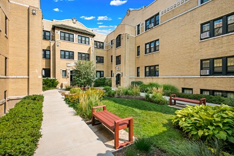 our apartments have a walkway with benches and grass