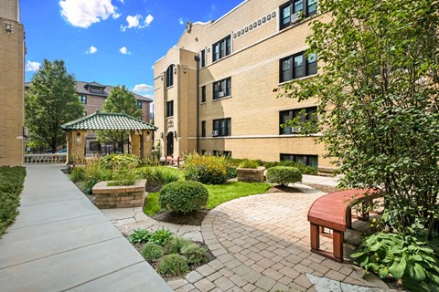 a brick building with a garden outside of it