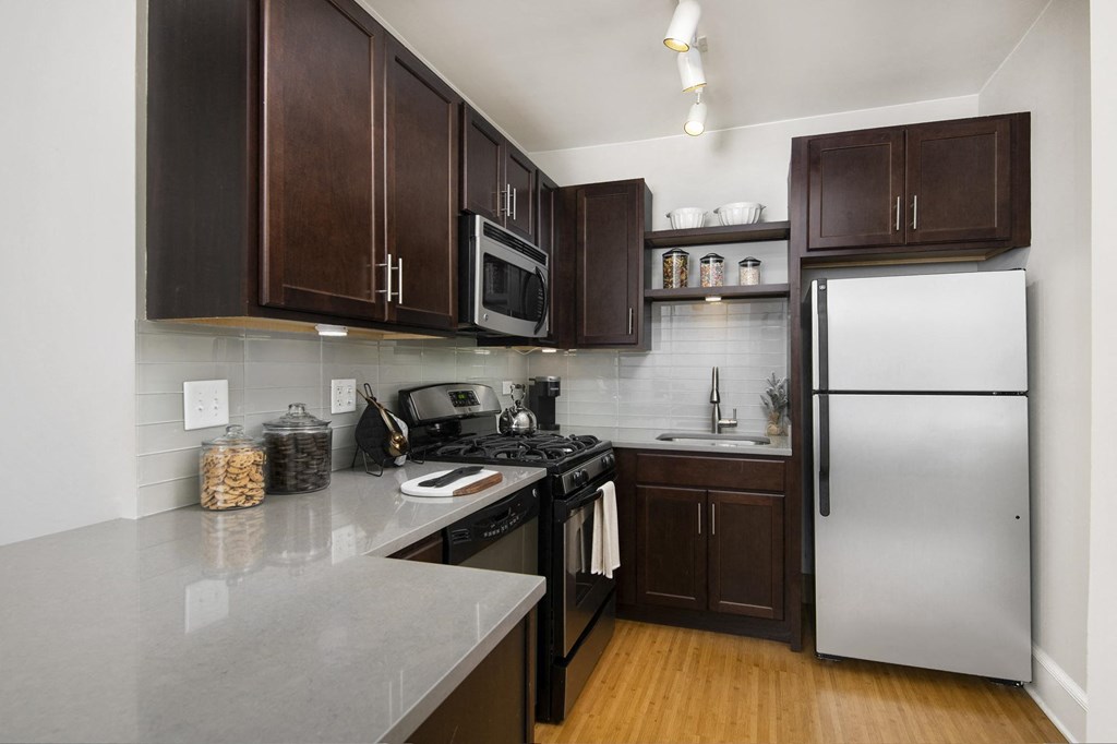 a kitchen with stainless steel appliances and wooden cabinets