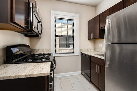 a kitchen with stainless steel appliances and a window