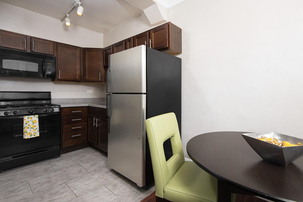 a kitchen with a stainless steel refrigerator and a table