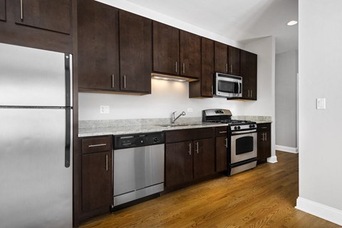 a kitchen with wooden cabinets and stainless steel appliances