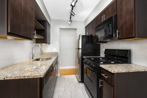 a kitchen with black appliances and granite counter tops and