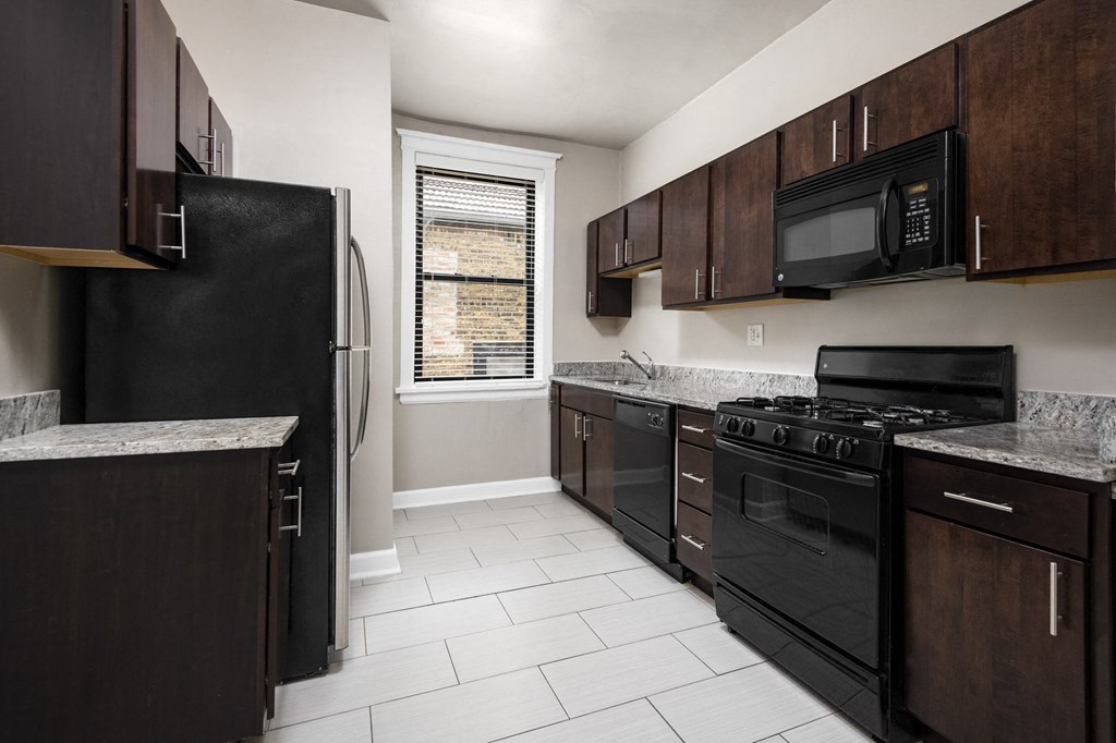 a kitchen with black appliances and wooden cabinets
