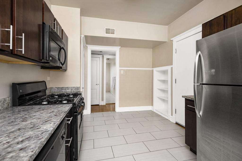 a kitchen with stainless steel appliances and marble counter tops