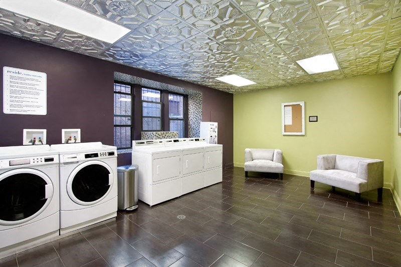 a laundry room with two washes and two washing machines