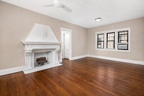 a living room with a fireplace and wood floors