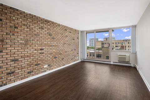 Living Room at Park Lincoln with Exposed Brick, Hardwood Floor and Floor to Ceiling Windows