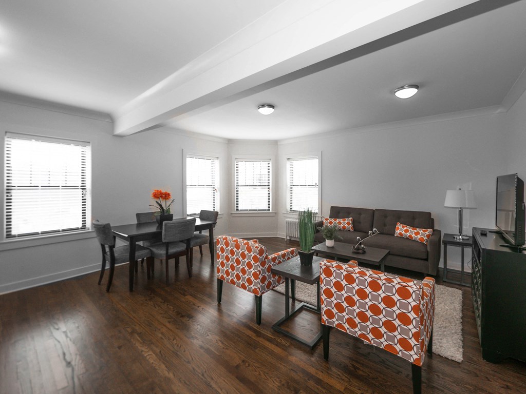 a living room with a couch and a table with chairs