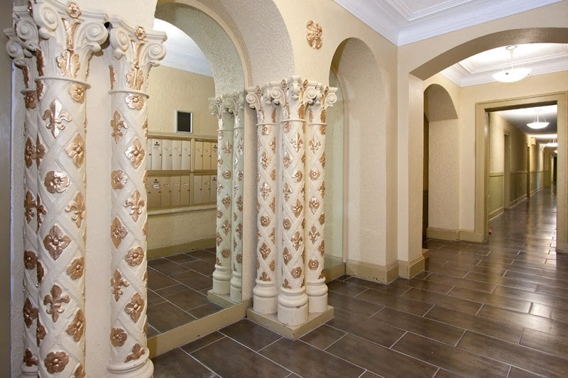 the lobby of a building with columns and a counter