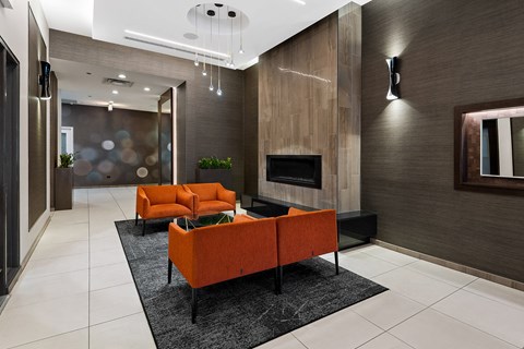 a living room with orange couches and a fireplace