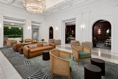 the lobby of a hotel with couches and chairs