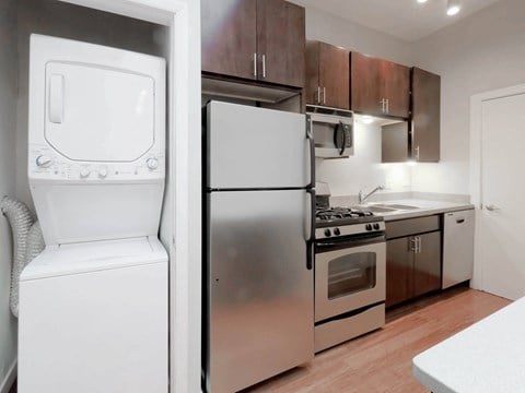 a kitchen with stainless steel appliances and a white refrigerator