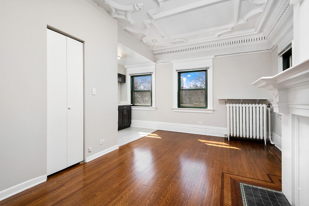 A room with wooden floors and white walls.