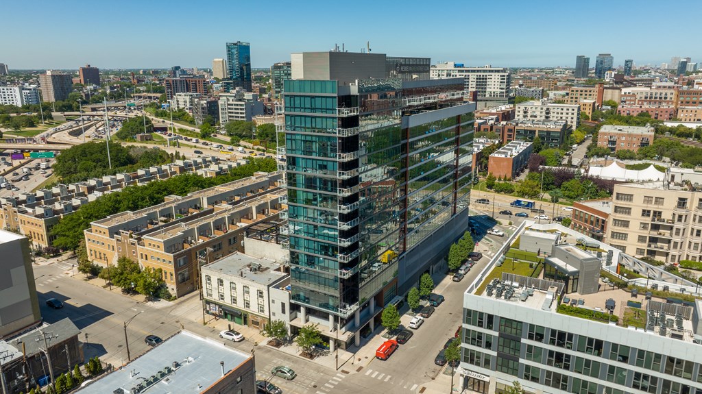 an aerial view of a tall building in a city