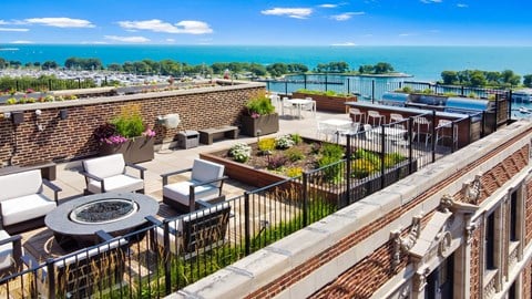 Community a rooftop terrace with a view of the ocean and a pool