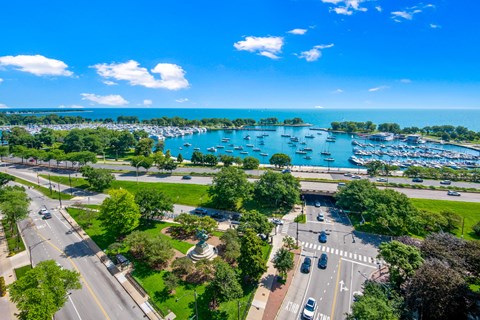 an aerial view of a parking lot with boats in a harbor