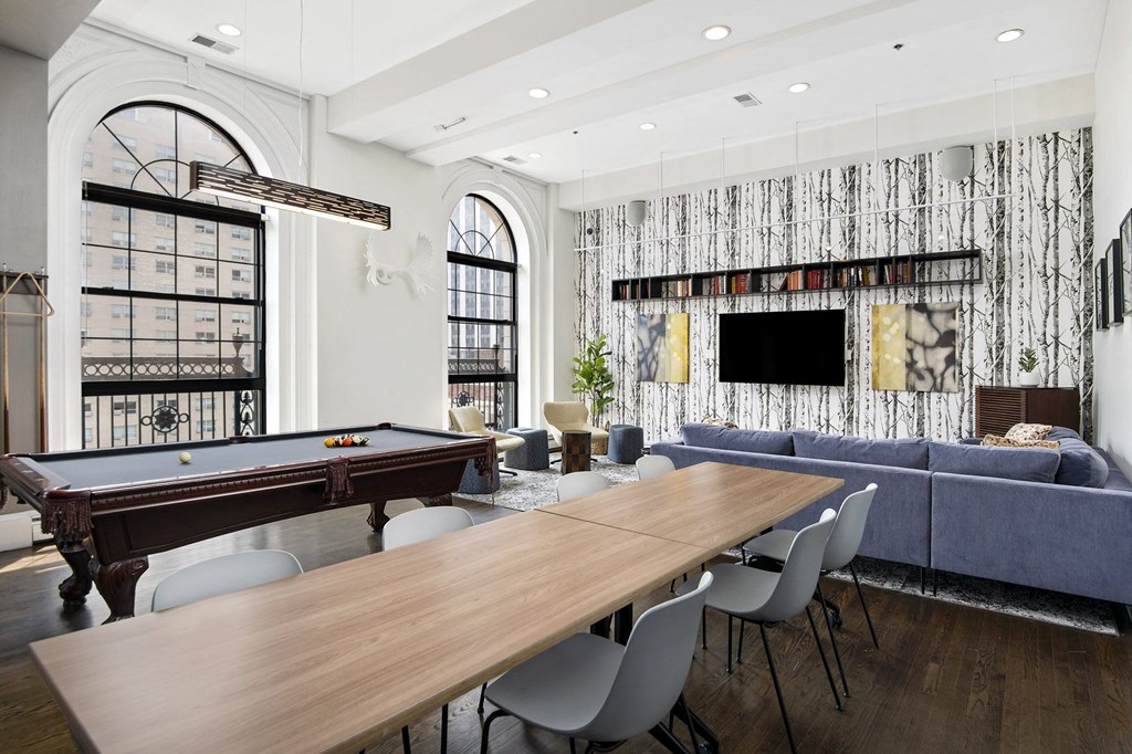 a living room with a pool table and a table and chairs