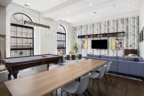 a living room with a pool table and a table and chairs