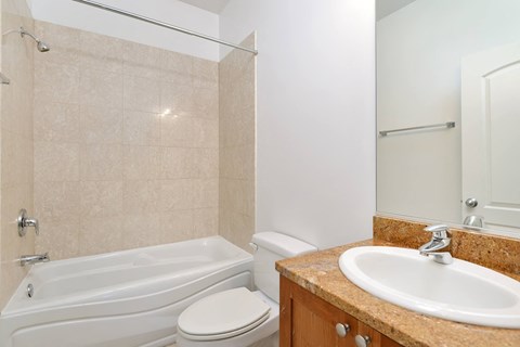 a bathroom with a sink toilet and a tub