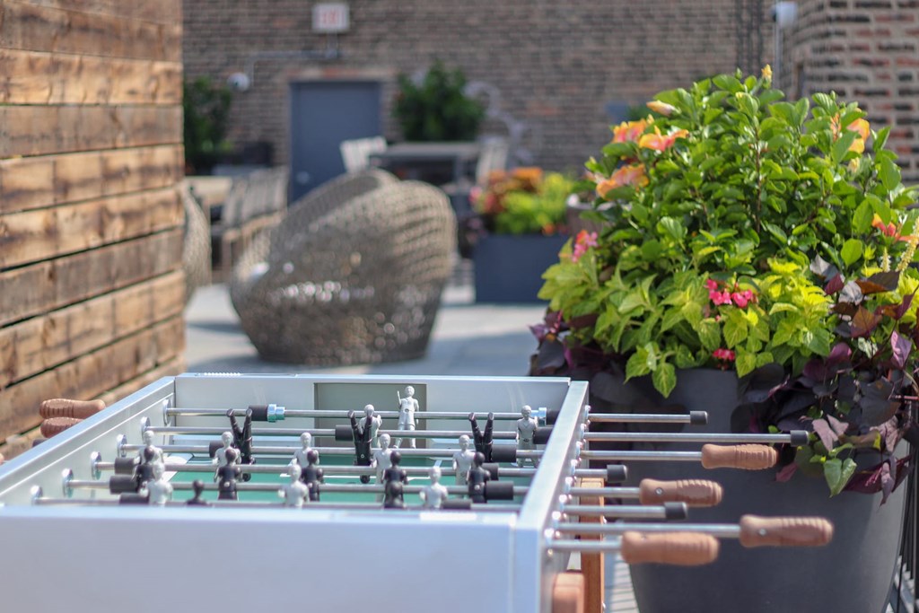 a foosball table on a patio with plants