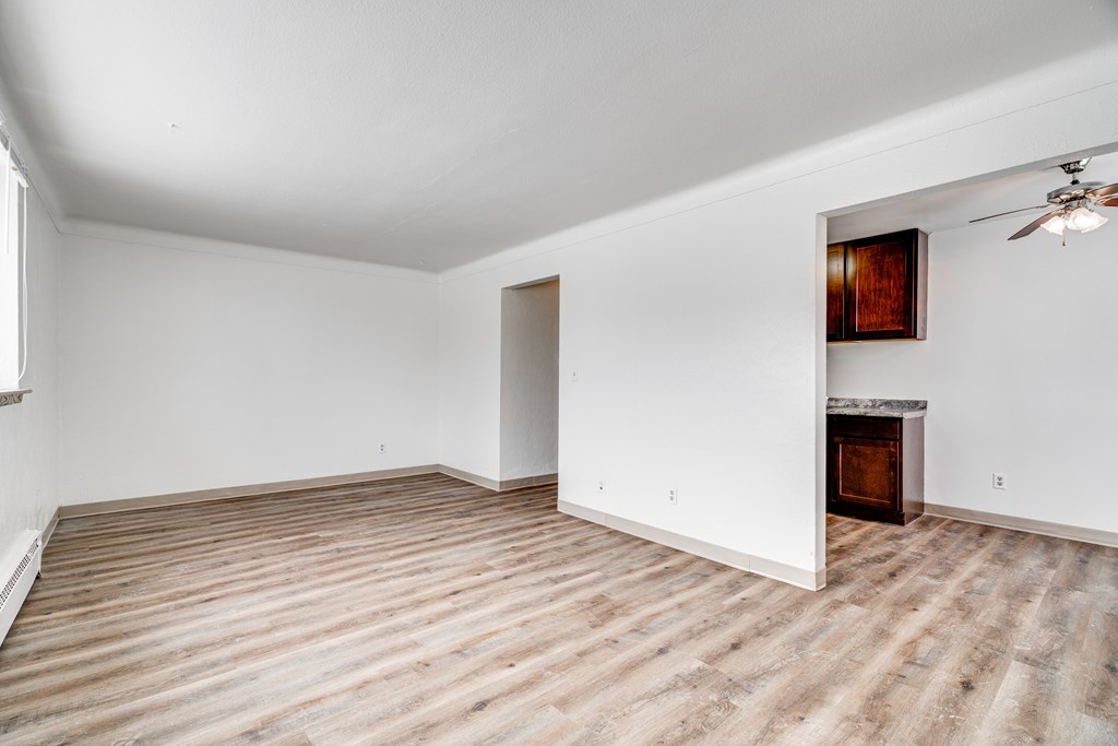 A room with a fireplace and a ceiling fan.