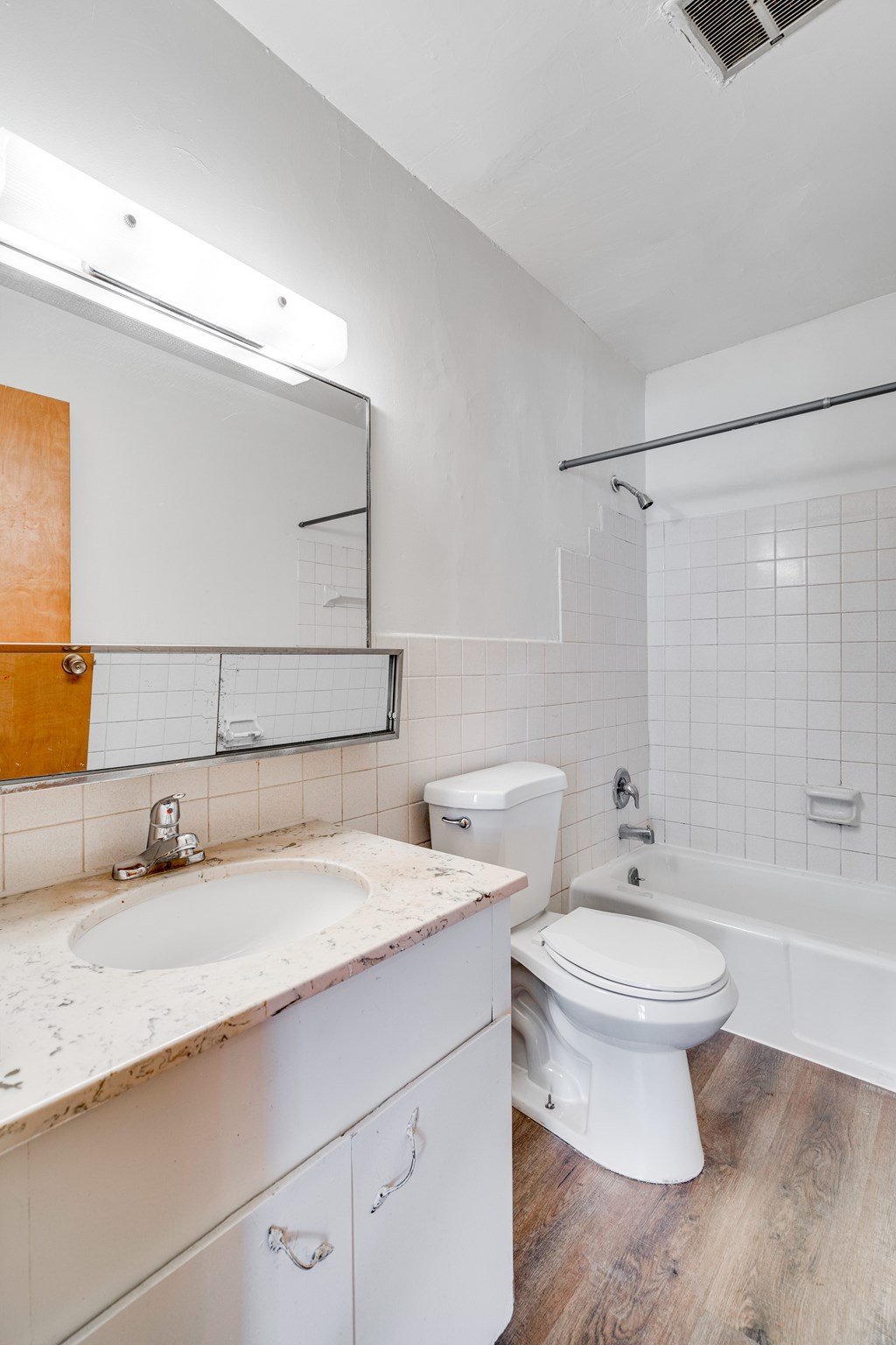 A white bathroom with a sink, toilet, and bathtub.