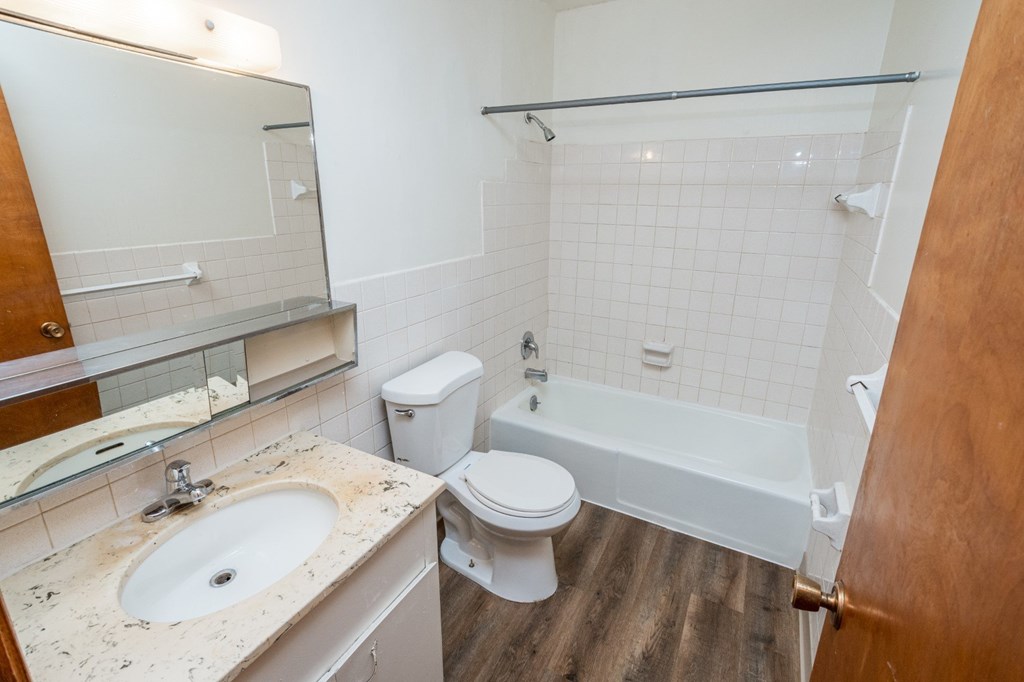 A bathroom with a sink, toilet, and bathtub.