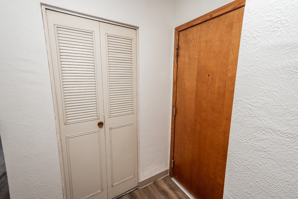 A white door with a brown door next to it.